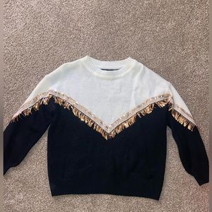 Size small sweater, black and cream color with sequin tassels.